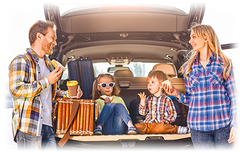 Happy family eating lunch in back of car