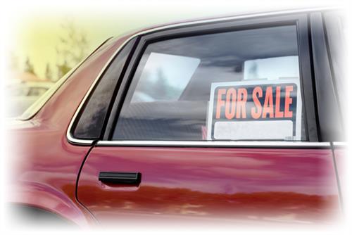 Car with for sale sign in window