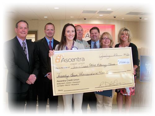 Ascentra staff present check to Rotary