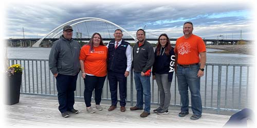 Team Ascentra with Bettendorf Mayor cleaning up the river