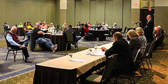 Board Members sitting at table during annual meeting