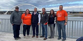 Team Ascentra with Bettendorf Mayor cleaning up the river