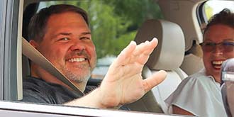 Dale Owen waving out of car window -es