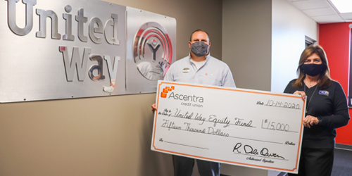 Man and woman holding check
