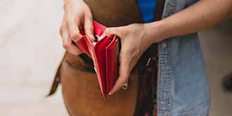 Someone reaching into their red wallet