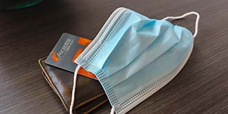 Ascentra credit card under blue face mask ES