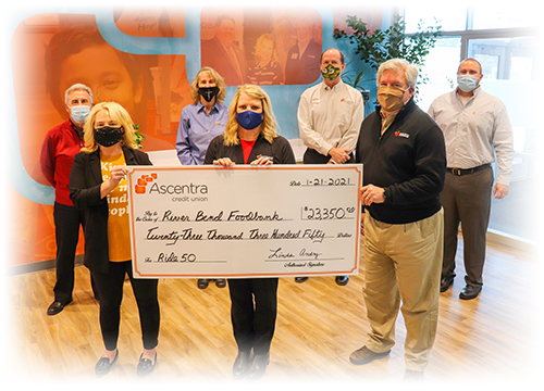 Check presentation with Ascentra staff and River bend food bank staff. 3 employees in the front holding the check and 4 in the back