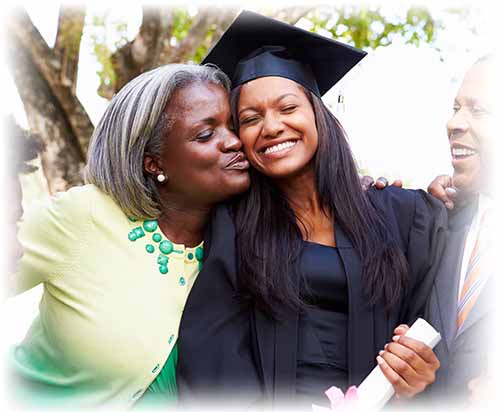 mother hugging daughter who is in a graduation cap and gown and holding her diploma