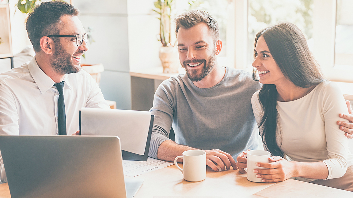 Couple drinking coffee with Mortgage Expert