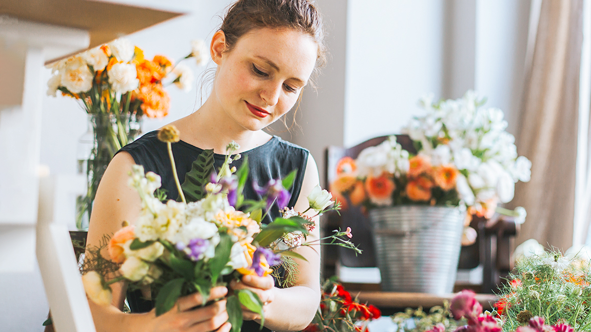 Woman arranging flowers