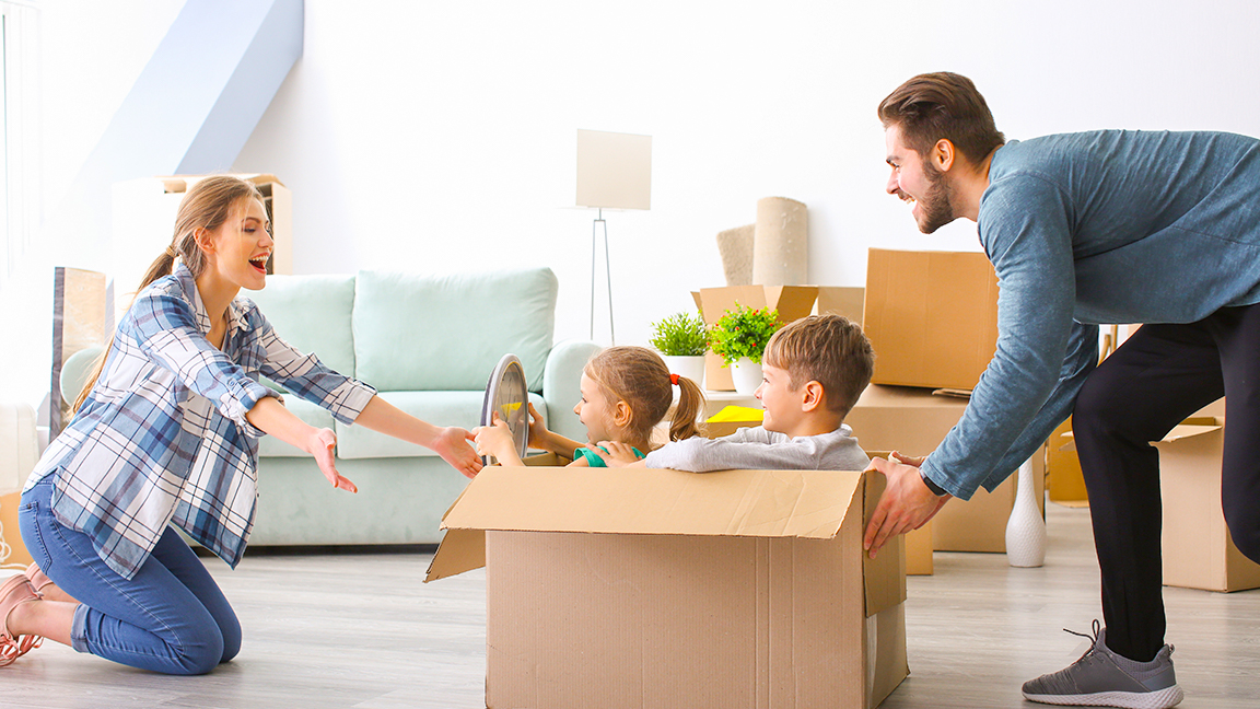 Parents playing with kids in moving boxes