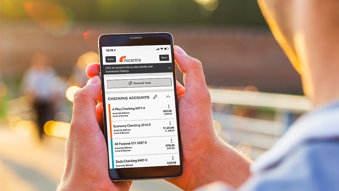 CrossSelling_MobileApp2020 Someone looking at their Ascentra Mobile App login screen