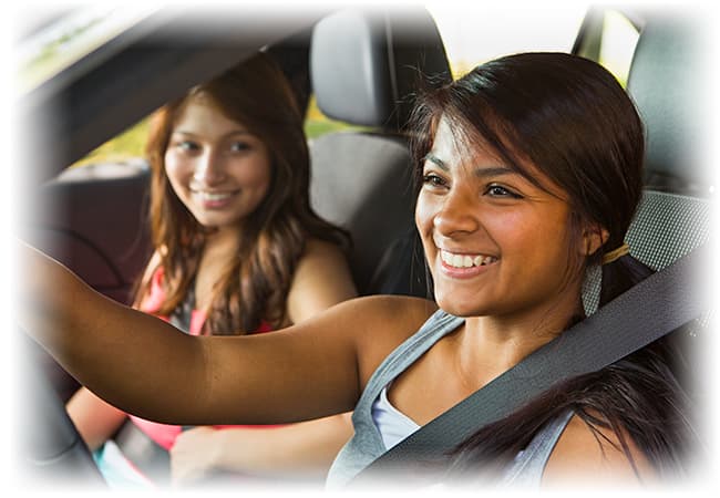 Girl driving car with another girl in the passenger seat