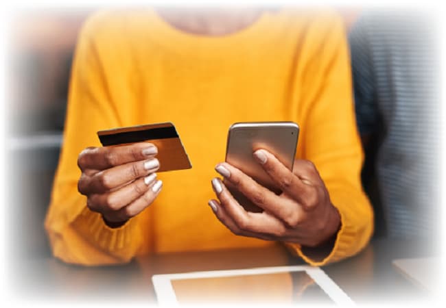 Person holding phone and debit card