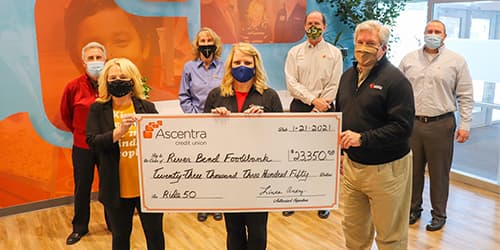 Ascentra staff and river bend foodbank staff during a check presentation to the river bend food bank.